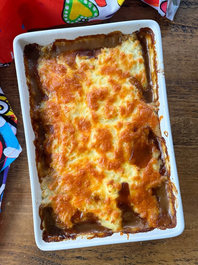 Sausage pie fresh out of the oven in a large white rectangle dish.